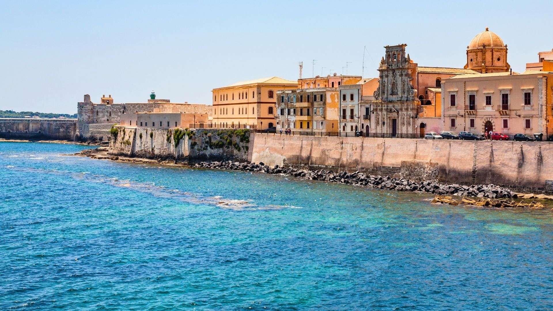Il lungomare di Ortigia con i palazzi affacciati sul mare turchese